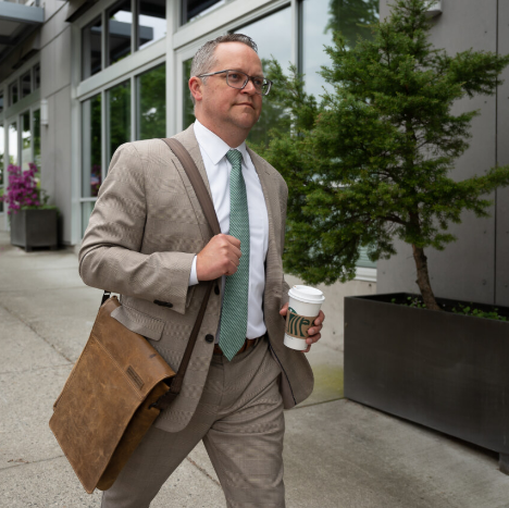 Man in suit walking on sidewalk